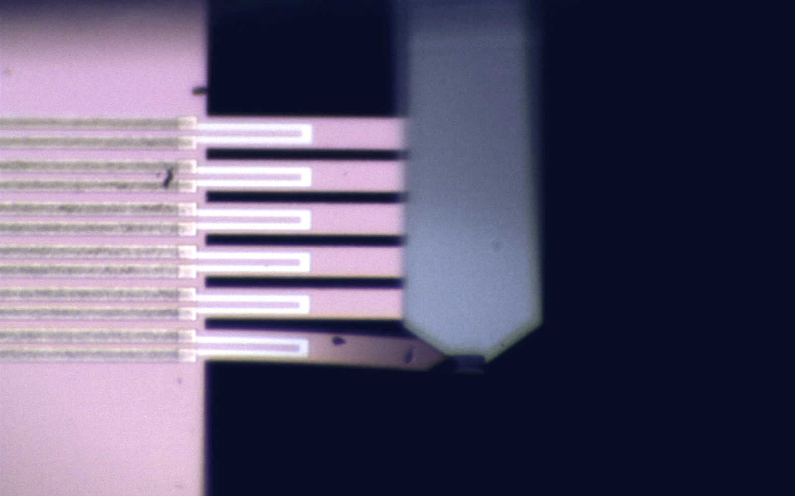 <p>MEMS testing apparatus measuring stiffness in micro-manufactured components for yield calculation.</p>